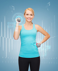 Image showing young sporty woman with light dumbbells