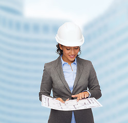 Image showing businesswoman in white helmet with blueprint