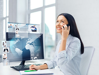 Image showing smiling businesswoman or student with smartphone