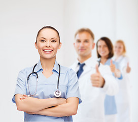 Image showing smiling female doctor or nurse with stethoscope