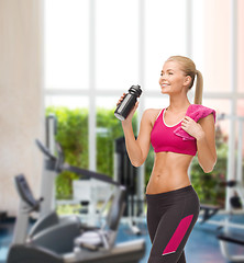 Image showing sporty woman drinking water from sportsman bottle