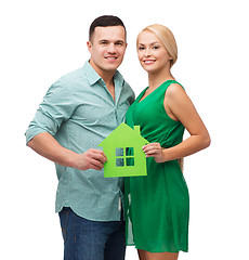 Image showing smiling couple holding green paper house