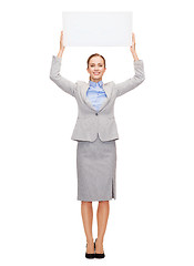 Image showing smiling businesswoman with white blank board