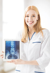 Image showing female doctor with x-ray on tablet pc