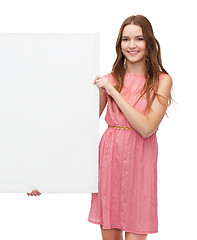 Image showing young woman in dress with white blank board