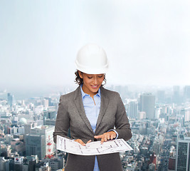 Image showing businesswoman in white helmet with blueprint