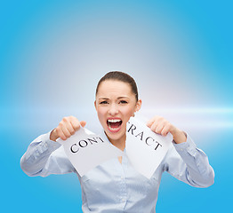 Image showing serious businesswoman tearing contract