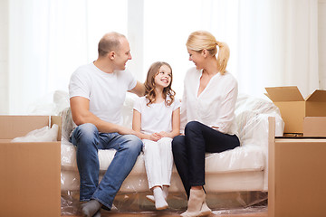 Image showing smiling parents and little girl at new home