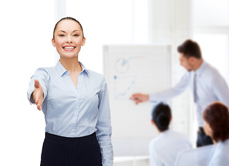 Image showing businesswoman with opened hand ready for handshake