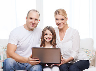 Image showing parents and little girl with laptop at home