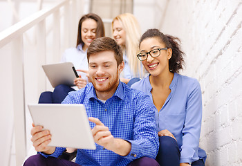 Image showing team with tablet pc computer sitting on staircase