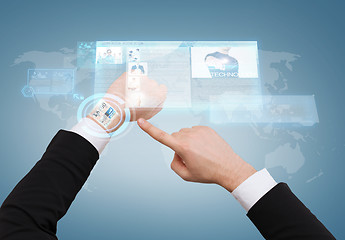 Image showing businessman pointing to virtual watch at his hand