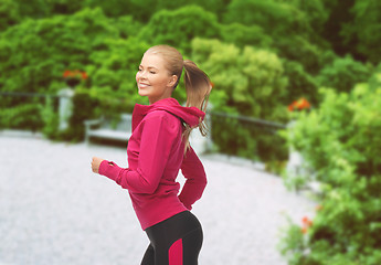 Image showing sporty woman running or jumping