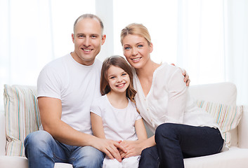 Image showing smiling parents and little girl at home