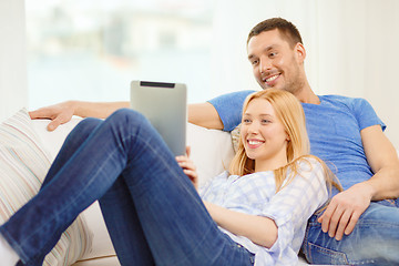 Image showing smiling happy couple with tablet pc at home