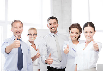 Image showing business team showing thumbs up in office