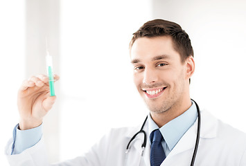 Image showing male doctor holding syringe with injection