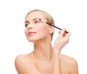 Image showing beautiful woman with makeup brush