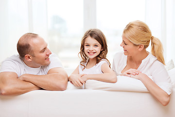 Image showing smiling parents and little girl at home