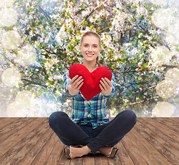 Image showing young woman in casual clothes sitting on floor