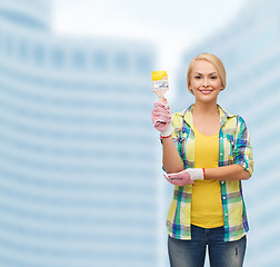 Image showing smiling woman with paintbrush