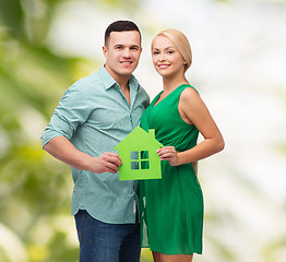 Image showing smiling couple holding green paper house