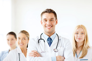 Image showing smiling male doctor in front of medical group