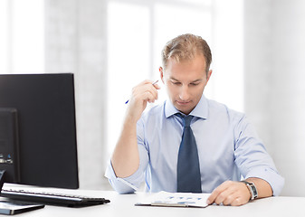 Image showing businessman writing in notebook