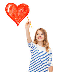 Image showing cute little girl drawing heart with brush