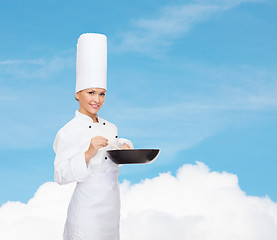 Image showing smiling female chef with pan and spoon