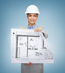 Image showing smiling architect in white helmet with blueprints