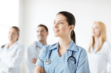 Image showing female doctor in front of medical group