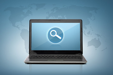 Image showing laptop computer with magnifying glass on screen