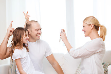 Image showing happy mother taking picture of father and daughter