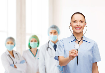 Image showing smiling female doctor or nurse with stethoscope