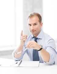 Image showing businessman with glasses showing warning gesture