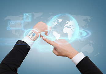 Image showing businessman pointing to virtual watch at his hand