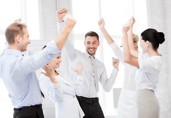 Image showing business team celebrating victory in office