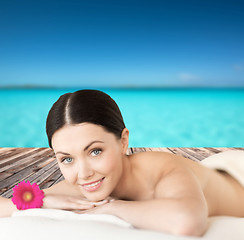 Image showing smiling woman lying on the massage desk