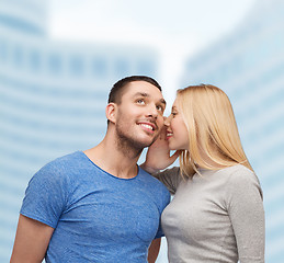 Image showing smiling girlfriend telling boyfriend secret