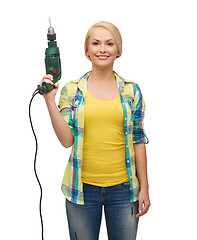 Image showing smiling woman with drill machine