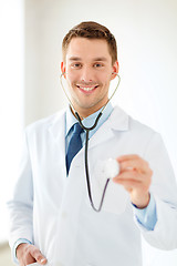 Image showing smiling male doctor with stethoscope in hospital