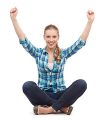 Image showing young woman in casual clothes sitting on floor