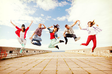 Image showing group of teenagers jumping