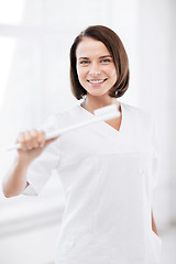 Image showing dentist with toothbrush in hospital