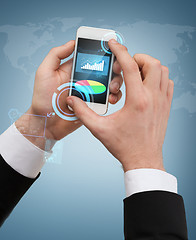 Image showing businessman touching screen of smartphone