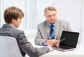 Image showing older man and young man with laptop computer