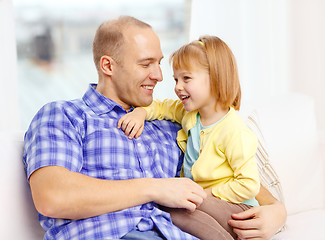 Image showing smiling father and daughter playing at home