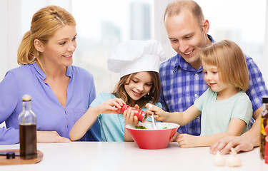 Image showing happy family with two kids making dinner at home