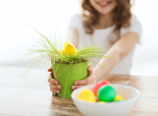 Image showing close up of girl holding pot with green grass